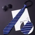 Detail view of a blue striped men's zipper necktie with fine fabric texture and neat stitching. - 011