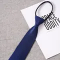 Blue zipper tie detail showcasing the smooth knot-free design and elegant patterned fabric. - Style 009