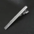 Silver metal tie clip detail shot, elegant business accessory with sparkling crystal accent. - Style 05