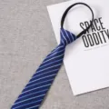 Blue striped zipper tie detail close-up showing fine fabric texture and neat stitching. - Style 028