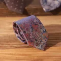 Classic paisley pattern men's necktie in navy blue with orange details, ideal for formal wear. - Orange Paisley Zipper Tie