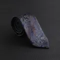 Detailed view of luxury men's vintage paisley tie in navy blue with elegant gold pattern. - Hand-Tied / Navy Blue Paisley