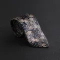 Luxury men tie detail shot, vintage paisley floral pattern on dark blue fabric texture. - Hand-Tied / Khaki Paisley