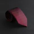Luxury dark red textured men's necktie detail shot, perfect for business formal wear and weddings. - Hand-Tied / Burgundy Textured