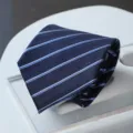 Close-up view of a classic navy blue striped business necktie with fine light blue lines. - Zipper Style / Blue White Twill
