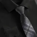 Close-up detail shot of a classic men business plaid tie paired with a dark formal dress shirt. - Black Gray Fashion Zipper Tie