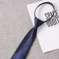 Detail shot of a dark blue zipper necktie with classic twill texture, pre-tied lazy design. - Style 017