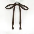 Close-up detail of dark brown ribbon tie for JK uniform, neat and stylish accessory. - Brown
