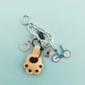 Detail shot of cute cat paw keychain with sparkling rhinestones, black cat and bicycle charms. - Khaki Cat Claw Style (B410-3) / Khaki