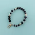 Detail view of black and clear beaded phone charm lanyard with lovely star and heart shapes. - X105-6 (Black White Dice)