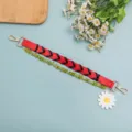 Short bag strap replacement with red braided leather, green beads and daisy charm for handbags. - Red And Black Woven Style (B447-2)
