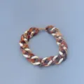 Close-up detail showcasing the stylish chunky acrylic and metallic chain link texture. - Two-Tone Brown and Gold