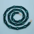 Detailed view of dark green acrylic chain strap with gold clasps for bags and phone cases. - Dual Green
