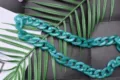 Close up detail of trendy teal acrylic bag chain strap, versatile handbag replacement accessory. - Bright Green