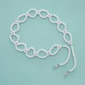 Detail shot of white beaded chain strap with metal clasps for bags and phone decoration. - Solid White