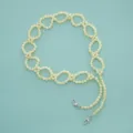 Close-up detail of the woven beaded chain strap featuring interlocking loops and metal clasps. - Luminous Yellow