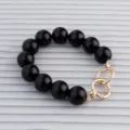 Black round beaded handbag strap replacement with shiny gold metal rings for purses. - Black