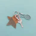 Star leather keychain with tennis racket metal pendant, detailed view of cute bag charm accessory. - Tennis Racket Style (B397-1)