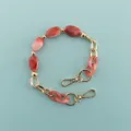 Details of the red marbled bead and gold hardware short phone case chain for daily use. - Red Marble Texture Chain