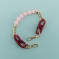 Detailed view of pink frosted star beads and dark red resin links on chic phone chain strap. - Pink Frosted Star Chain