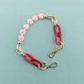 Short phone case chain with pink cat paws and red resin links, stylish and cute accessory. - Pink Cat Paw Beaded Chain