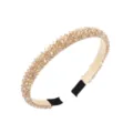 Detailed close-up view of elegant champagne crystal rhinestone headband with black tips. - Champagne