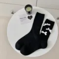 Chic black mid-calf socks featuring sweet white bow accents, soft cotton blend for women. - Black + White Bow
