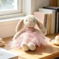 Cute plush bunny toy wearing a sweet pink dress, soft and cuddly companion for kids. - Brown Rabbit