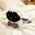 Cute black-faced sheep plush toy, soft stuffed animal doll for kids and home decor. - Goat