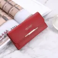 Red long wallet for women, elegant folding clutch with card slots and sleek metal decor. - Red