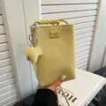 Cute mini leather phone bag for women with elephant charm and braided strap in yellow color. - Litchi Pattern Yellow