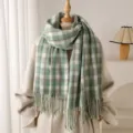 Detailed view of the green and white plaid imitation cashmere scarf with elegant fringe. - Green