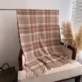 Close-up detail view of a cozy brown plaid cashmere-feel fringed shawl and scarf for autumn - Dark Brown