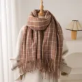 Detail view of a cozy brown plaid cashmere-feel fringed scarf, stylish autumn and winter warm accessory. - Brown