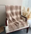 Cozy brown plaid boucle cashmere-feel scarf detail showcasing soft tassel edge and warm texture. - Brown