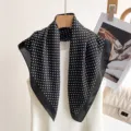 Detailed shot of black and white polka dot silk square scarf, elegant neck accessory texture. - Black