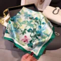 Detail shot of floral silk square scarf with green border and butterfly print for women fashion. - 66-70cm / Green