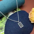 Close-up shot of the sparkling rhinestone abacus pendant necklace equipped with a delicate chain. - Paved Abacus