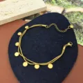 Detail shot of gold double layer necklace with small round disc pendants and extension chain. - Round Disc Bracelet
