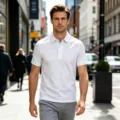 Detailed view of breathable white polo shirt with short sleeves and collar for urban men daily wear. - S / Tops / White