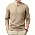 Men's waffle knit long sleeve henley shirt close up showcasing textured fabric and button placket. - Khaki