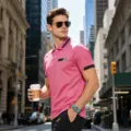 Close-up of men's pink polo shirt with contrast collar and chest design in urban street setting. - S / Tops / Watermelon red