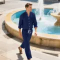 Detailed view of a men's dark blue linen long-sleeve shirt and trousers set worn outdoors. - S / Top And Bottom / Dark Blue