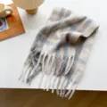 Detailed view of the soft winter plaid tassel scarf showing cozy fabric and fringe texture. - Style 1
