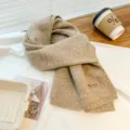 Detail view of the warm knitted scarf texture, soft fabric close-up, cozy autumn winter style. - Dark Khaki
