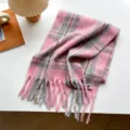 Detailed view of cozy pink and grey plaid winter scarf with soft tassel fringe texture. - Style 5