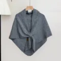 Detailed view of the cozy grey knit shawl texture, elegant draping and knot design, warm winter accessory. - Slate Gray