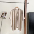 Detailed view of women's summer beige knit sun protection shawl cape with single front button. - 85*125cm / Light Apricot