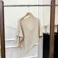 Knitted poncho detail view, beige woolen shawl texture and metal button decoration showcase. - 50*75cm / Beige