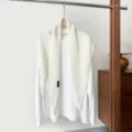 Detailed close-up view of white knitted hollow triangle shawl scarf outer wear, premium knit. - White